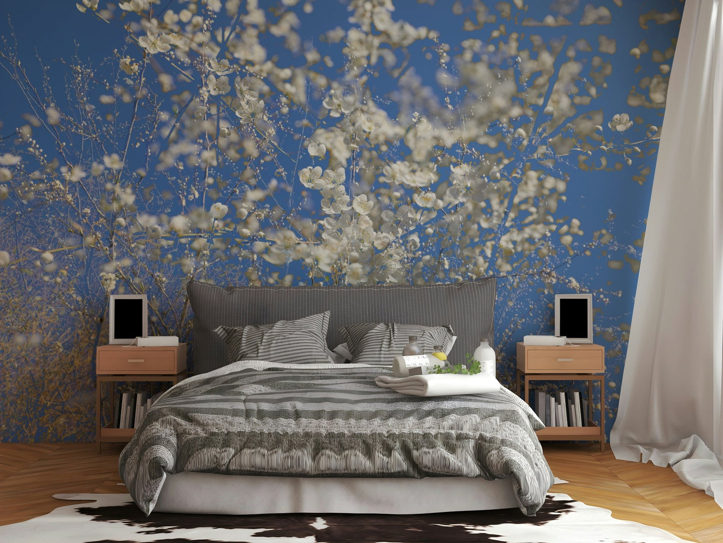 White Blossoms Against a Clear Blue Sky spring photography wall mural behind a gray striped bed with cowhide rug in a bedroom