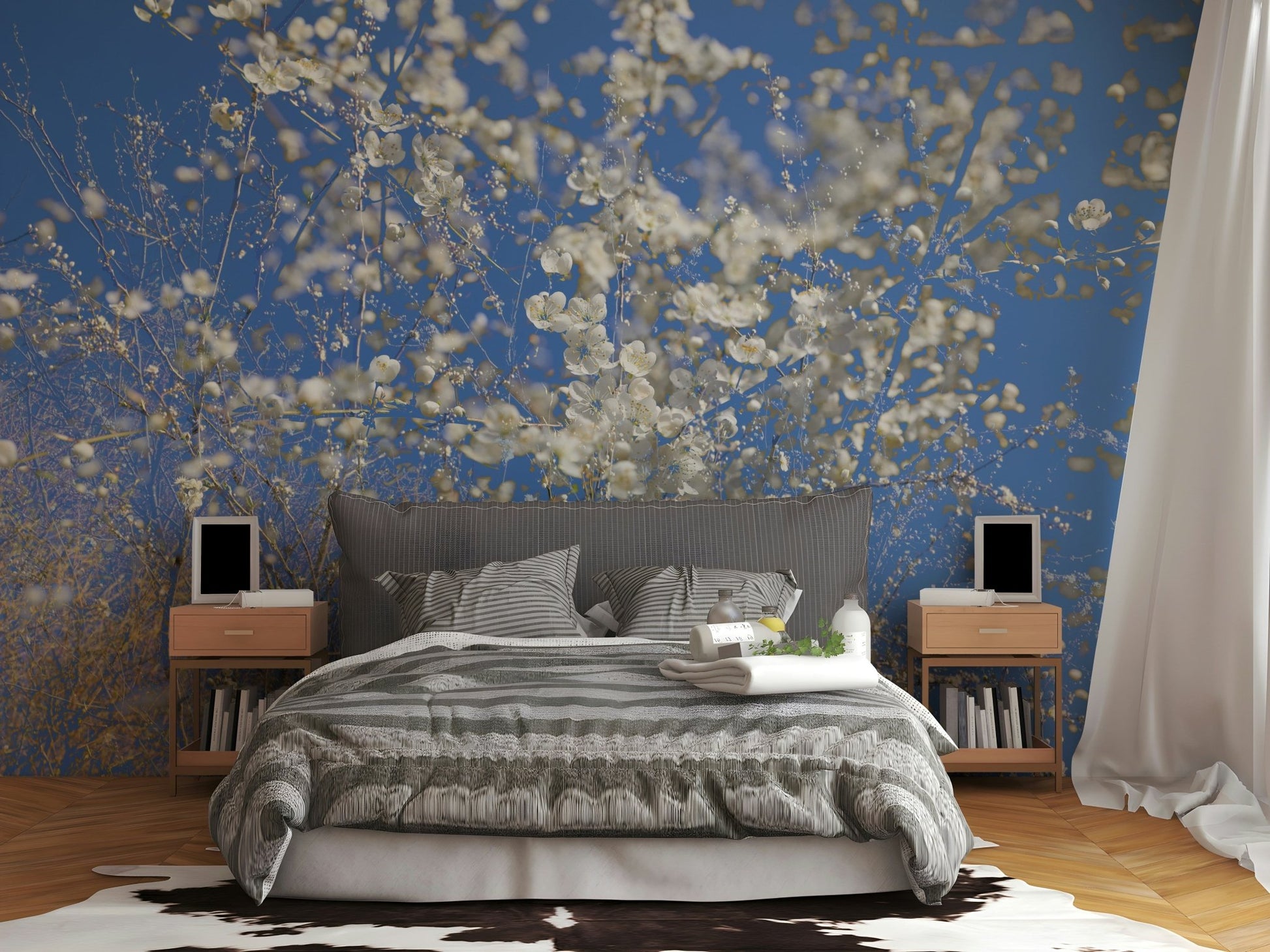 White Blossoms Against a Clear Blue Sky spring photography wall mural behind a gray striped bed with cowhide rug in a bedroom