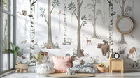 White Forest wallpaper of birch woodland animals above floor cushions with blush pillows in a kids playroom