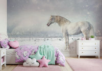 Snowdrift Horse wallpaper mural showing a white horse in snow above a pink ruffled bed in a girls bedroom