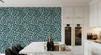 White Vines on Teal wallpaper as an accent wall in a white kitchen with a marble island and black bar stools