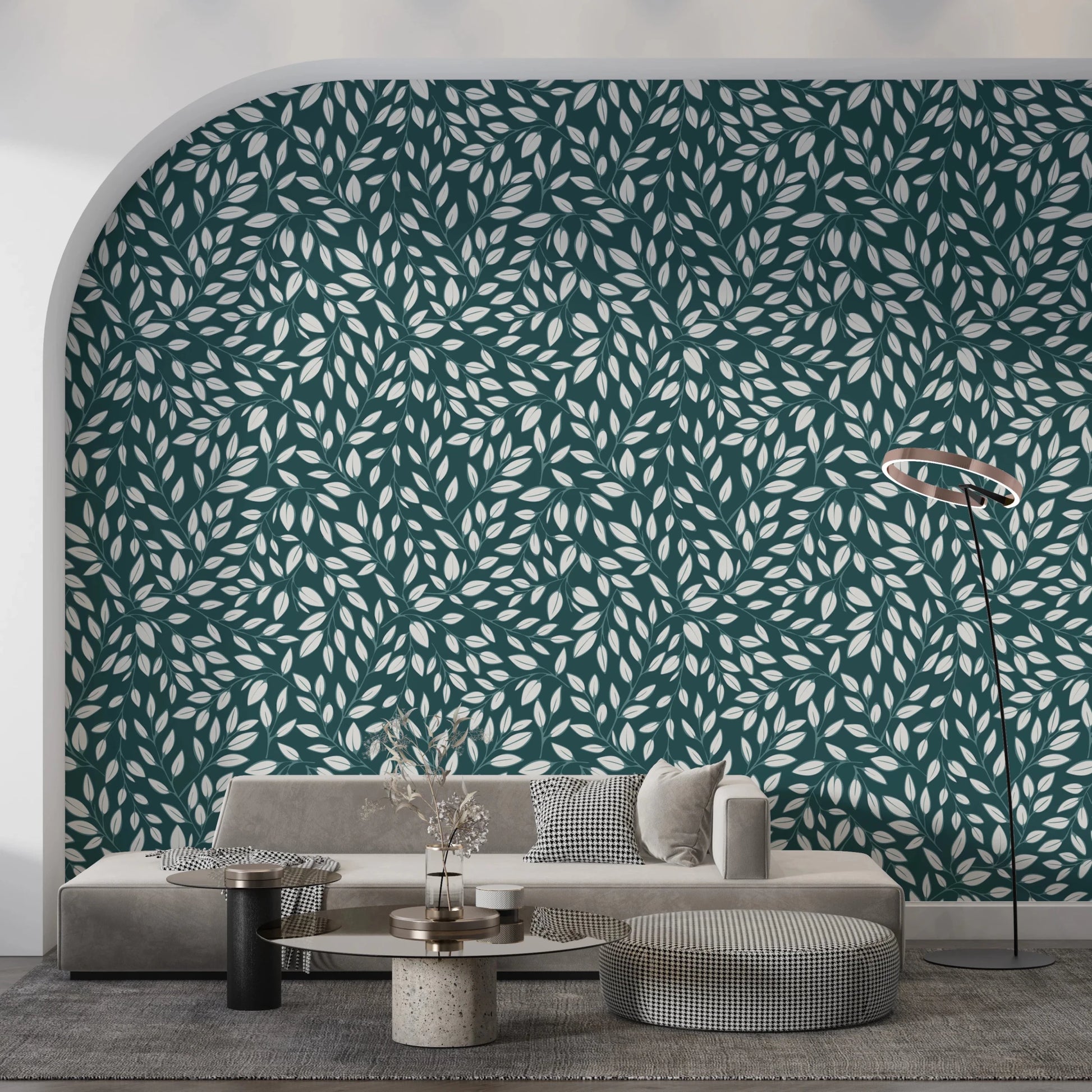 White Vines on Teal wallpaper on an arched wall behind a grey sofa with a round travertine table