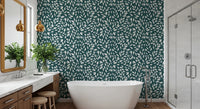 White Vines on Teal wallpaper behind a freestanding tub and marble vanity with gold pendants in a bathroom