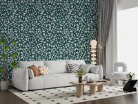White Vines on Teal wallpaper behind a white sofa with a daisy pillow and a stacked orb floor lamp