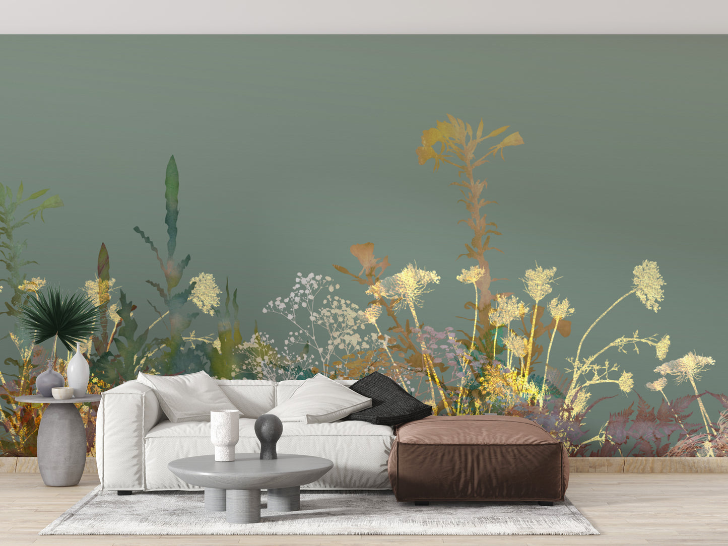 Wild Flower Design Art wallpaper mural in sage green behind a white sofa and brown leather ottoman in a living room