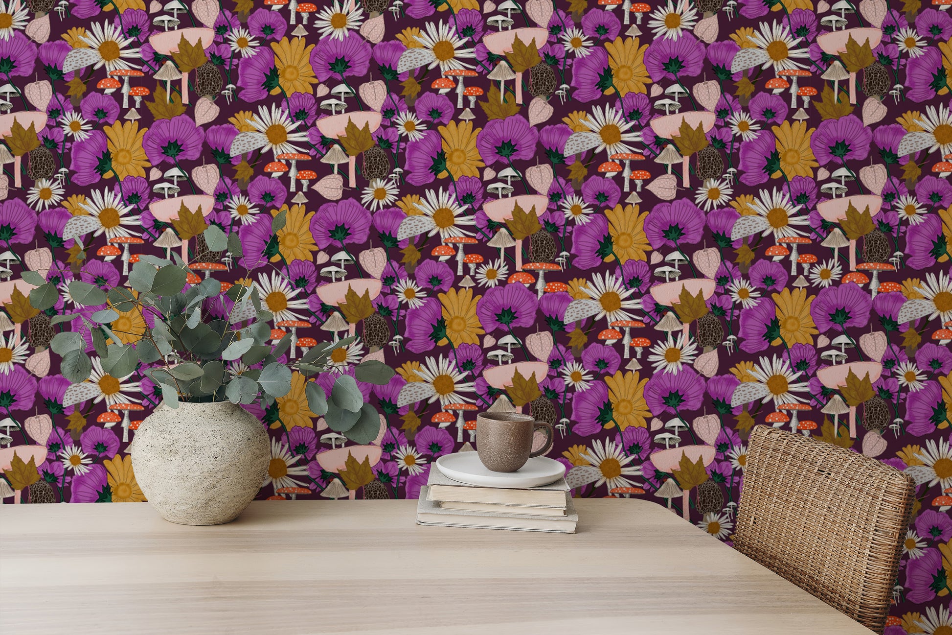 Wild Flowers and Mushrooms Purple wallpaper with magenta blooms and daisies behind a wooden table with a eucalyptus vase