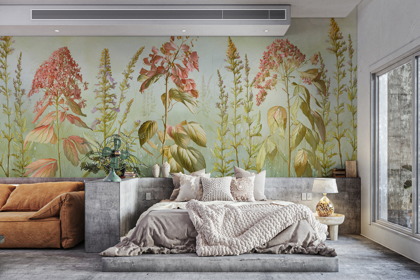 Wild Flowers Meadows wallpaper mural of coral blooms behind a platform bed and rust sofa in a modern bedroom