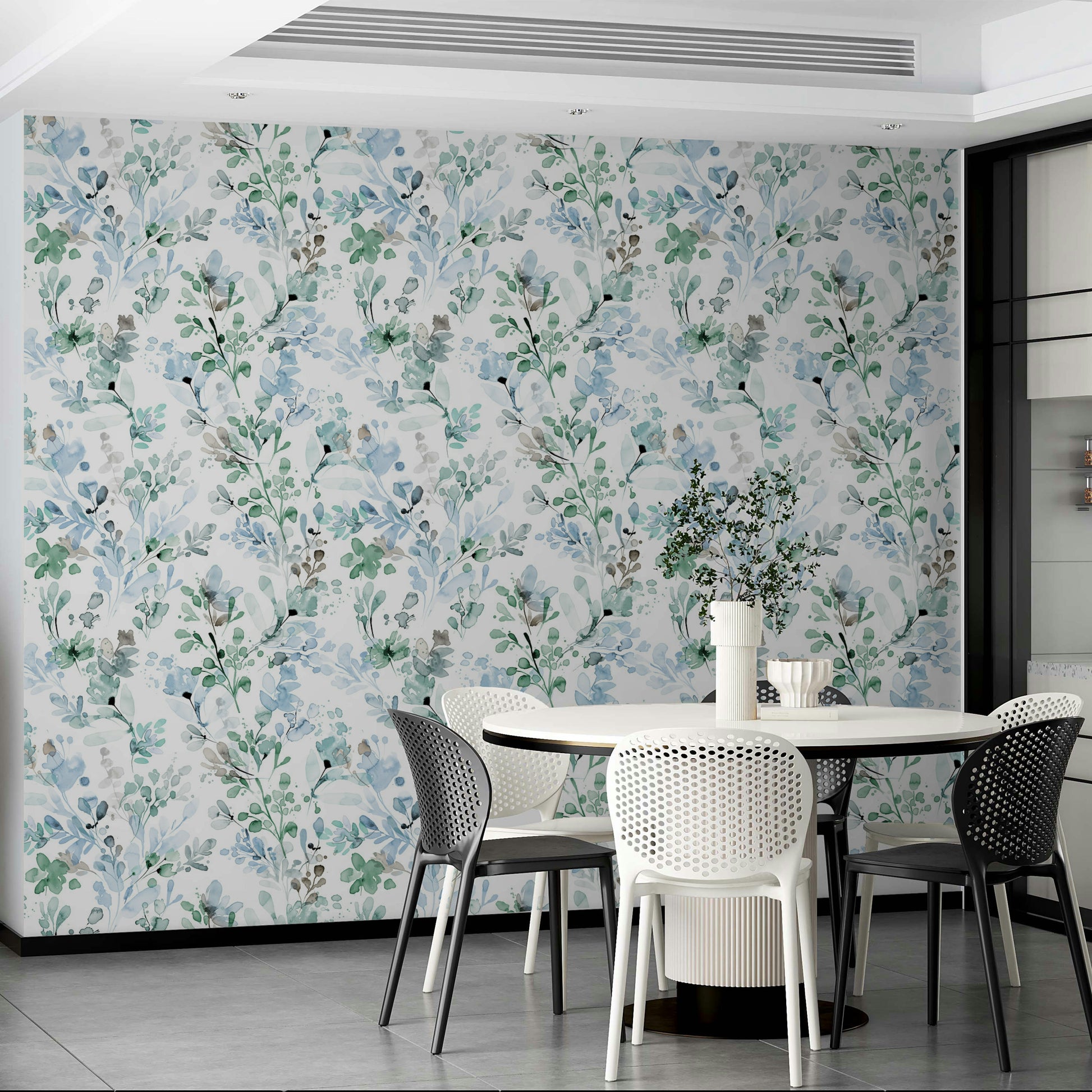 Sage green botanical print in a contemporary bathroom with brass taps and mirrors.