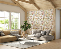 Soft gold botanical wallpaper in a primary bedroom with white bedding and brass lamps.