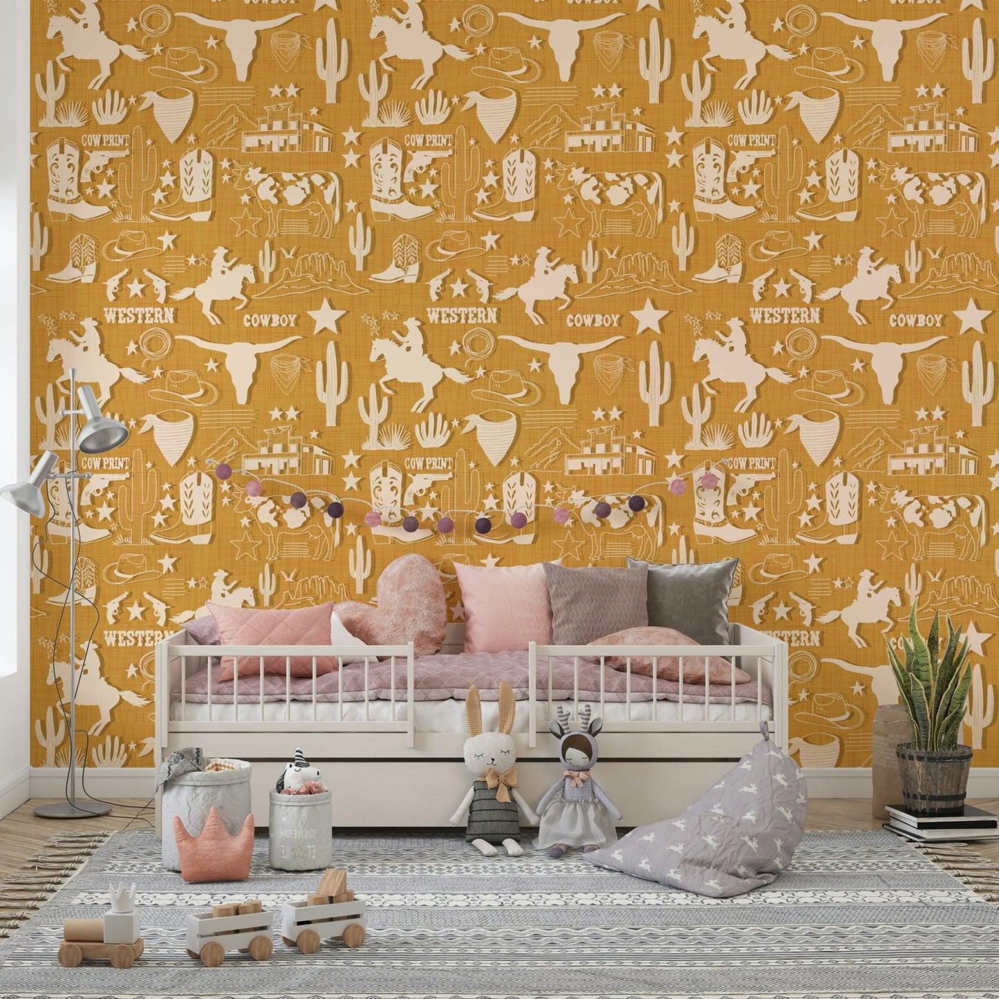 Rustic wallpaper mural with repeating Western motifs including horses, cacti, longhorns, and stars.