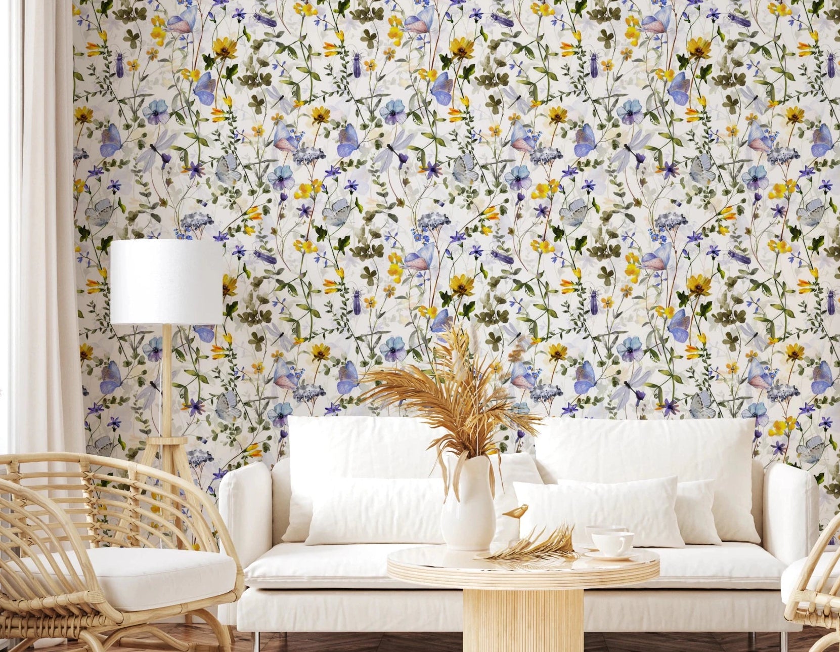 Wildflower Waltz wallpaper mural in a living room with a white sofa, rattan chair and round wooden coffee table