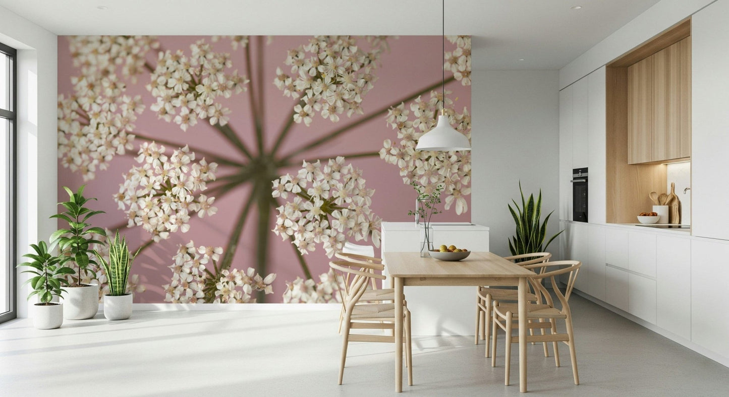 White and green wildflower stems on a pastel pink wall covering.