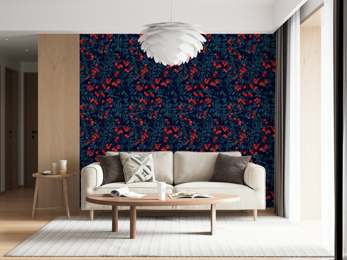 Winter Berries wallpaper in navy and red behind a cream sofa and oval wood table in a living room