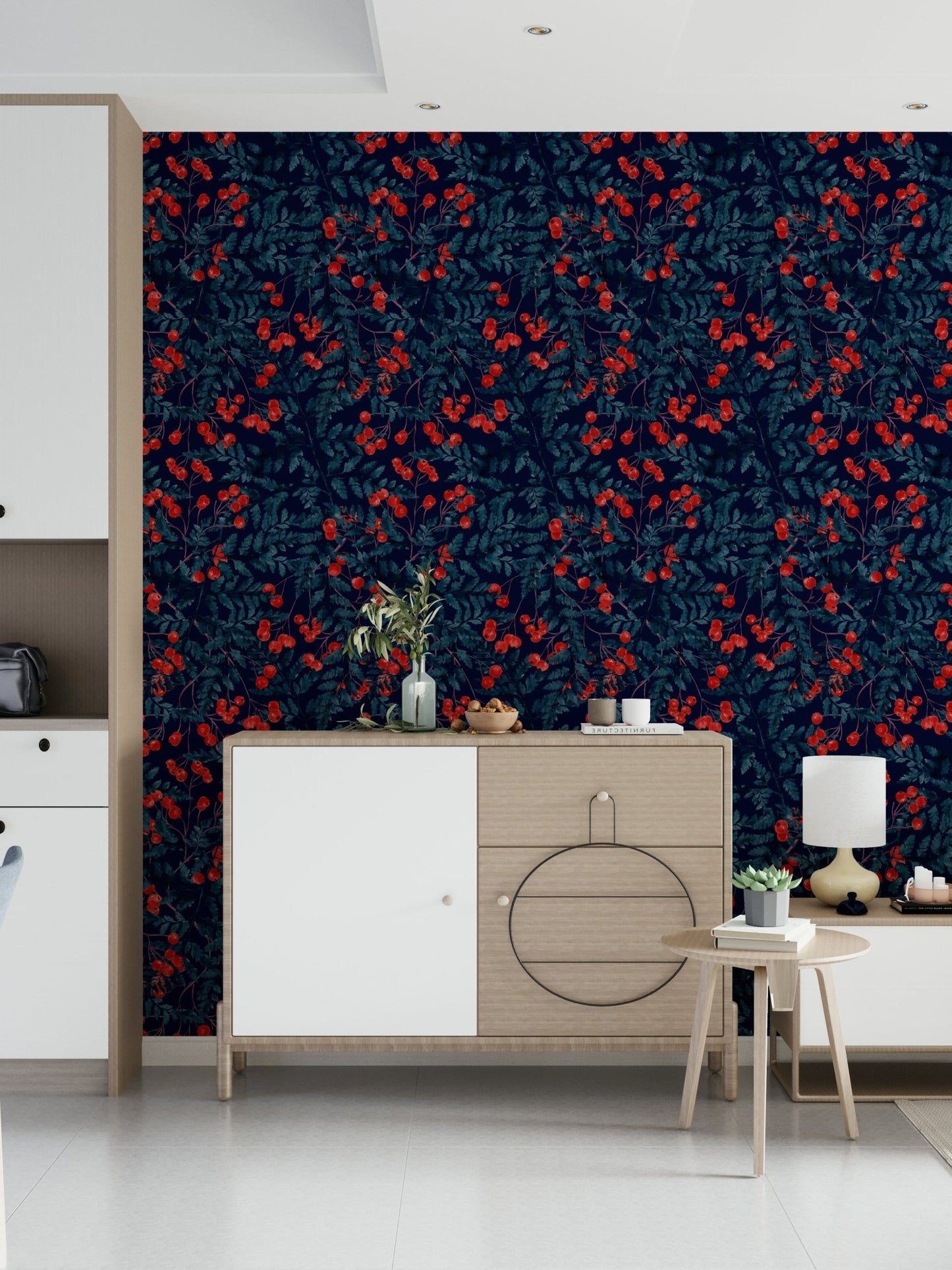 Winter Berries wallpaper in navy with red berries behind a wood and white console in an entryway