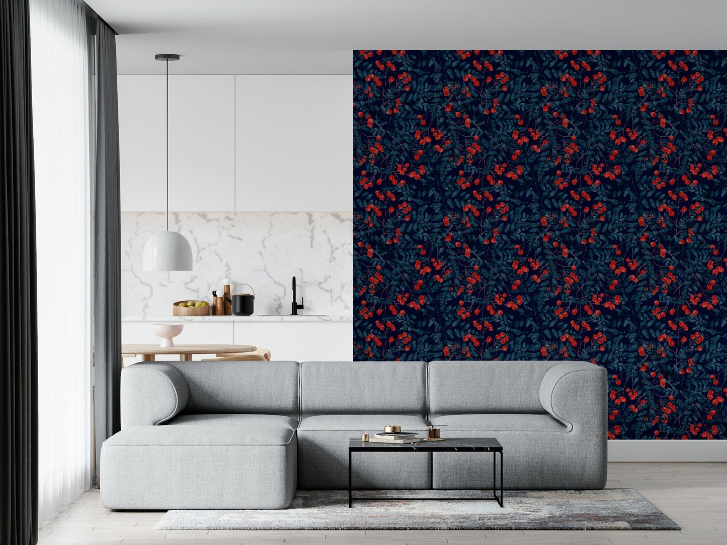 Winter Berries wallpaper in navy with red berries behind a grey sectional sofa near an open kitchen