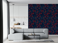 Winter Berries wallpaper in navy with red berries behind a grey sectional sofa near an open kitchen