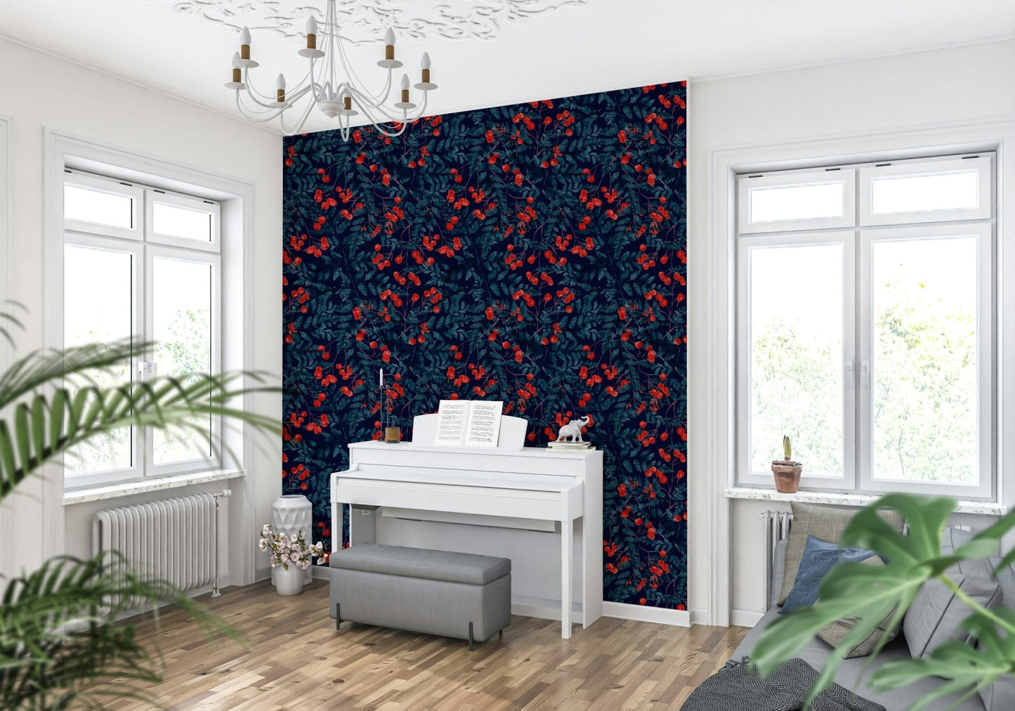 Winter Berries wallpaper in navy and red behind a white upright piano under a chandelier in a living room