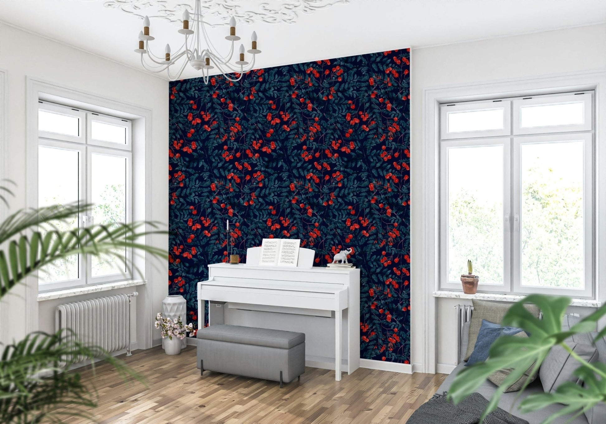 Winter Berries wallpaper in navy and red behind a white upright piano under a chandelier in a living room