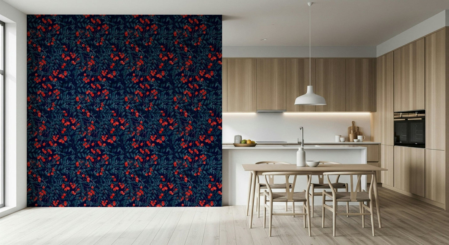 Winter Berries wallpaper in navy with red berries behind a light wood table and wishbone chairs in a kitchen
