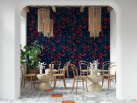 Winter Berries wallpaper in navy and red behind bentwood chairs and rattan pendants in a cafe