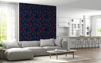 Winter Berries wallpaper in navy and red behind a grey sectional sofa by a white kitchen