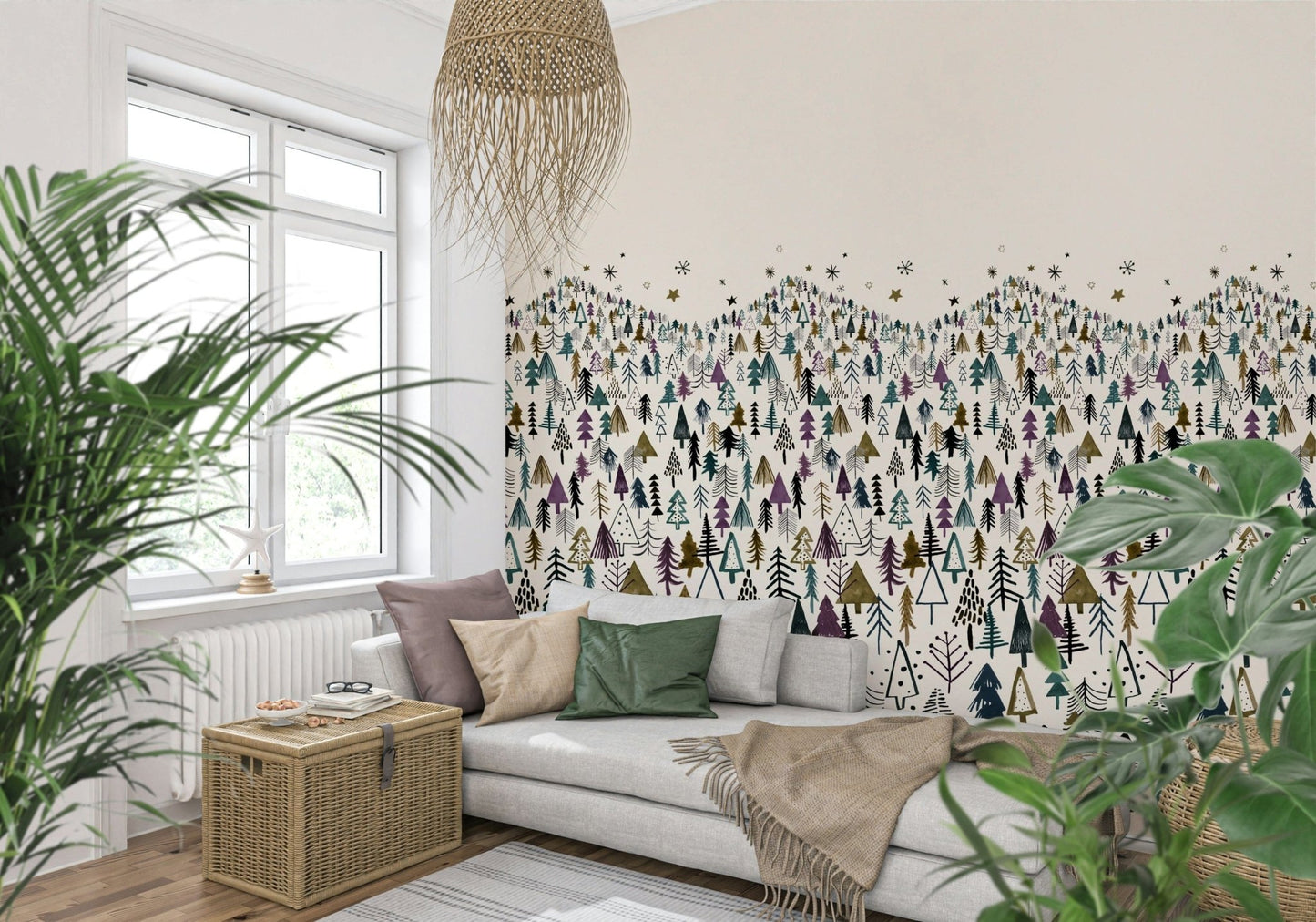 Winter Tree Wonderland wallpaper mural of stylized pines behind a grey sofa with plants and a wicker chest