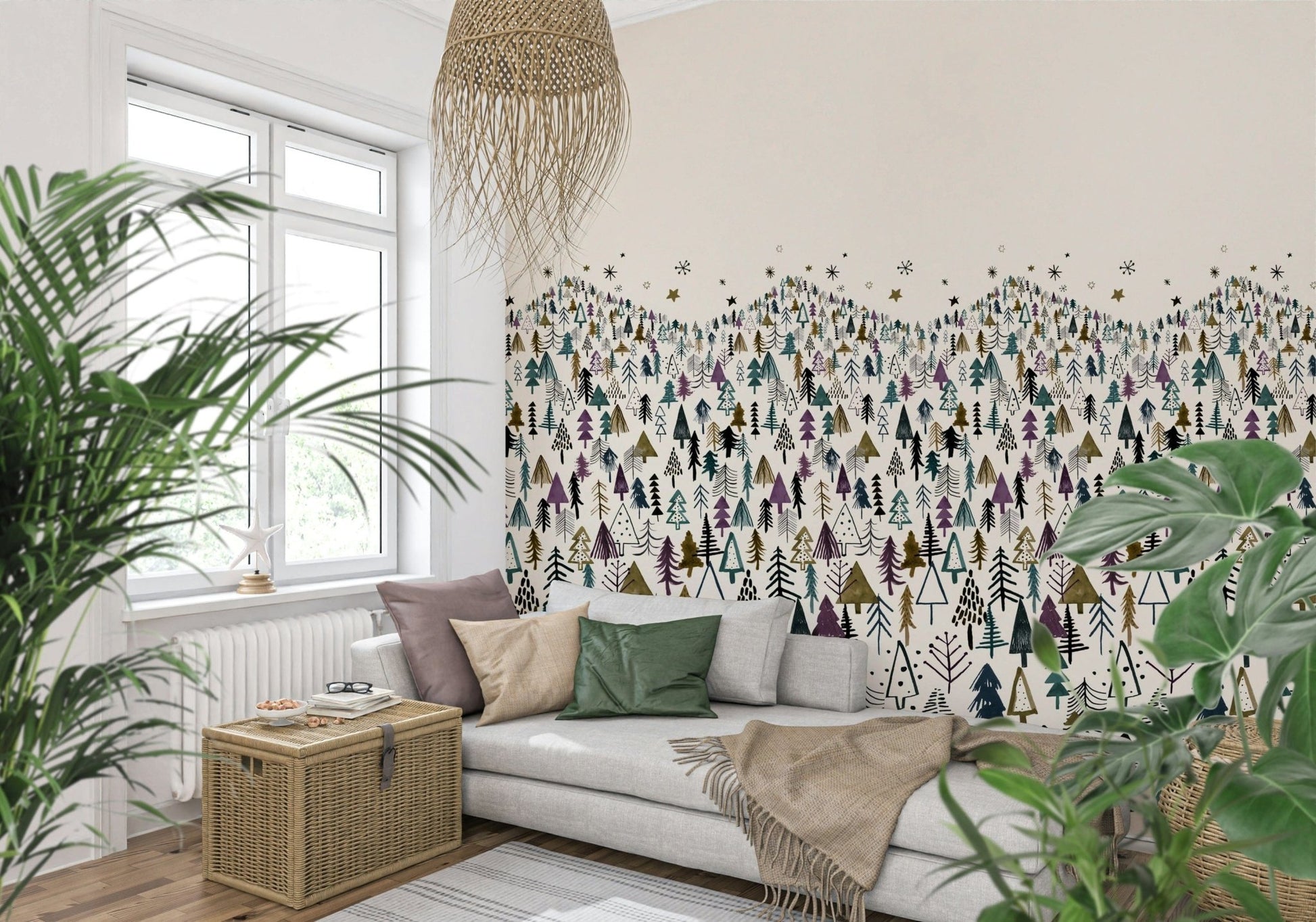 Winter Tree Wonderland wallpaper mural of stylized pines behind a grey sofa with plants and a wicker chest