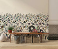 Winter Tree Wonderland wallpaper mural of stylized pines above a wooden console with baskets and vinyl