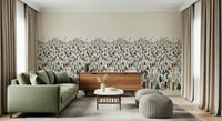 Winter Tree Wonderland wallpaper mural of pine forest behind a sage green sofa and wooden sideboard