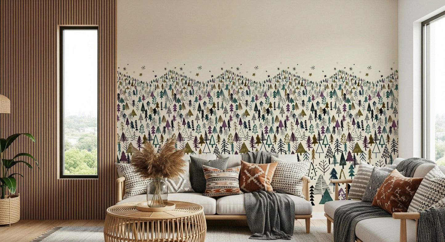 Winter Tree Wonderland wallpaper mural of stylized pines behind a white sofa with boho cushions in a lounge