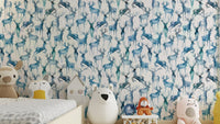 Wintery Artistic Deers Blue Wallpaper in a modern living room with gray furniture.