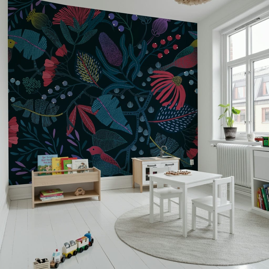 Wonderforest wallpaper mural in navy with pink blooms behind a white kids table and book bins in a playroom