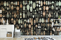 Woodcut Vase Design wallpaper mural of patterned vases on black behind a white sideboard in a kids room