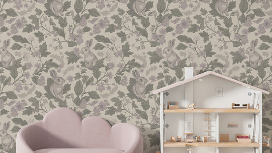 Woodland Garden Dusty Lavender wallpaper mural with mauve rabbits and foliage beside a pink sofa and white dollhouse