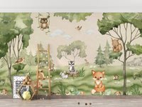 Woodland Joy Kids wallpaper mural with forest animals and an owl above a wood ladder shelf in a kids room