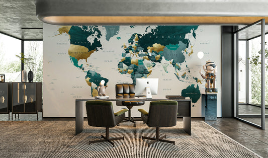 World Map Teal Gold wallpaper mural with gold-leaf accents behind a dark desk and green leather chairs in a glass-walled home office
