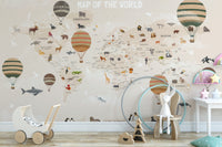 World Map Kids & Nursery wallpaper in beige with animals and hot air balloons above a wooden toy pram