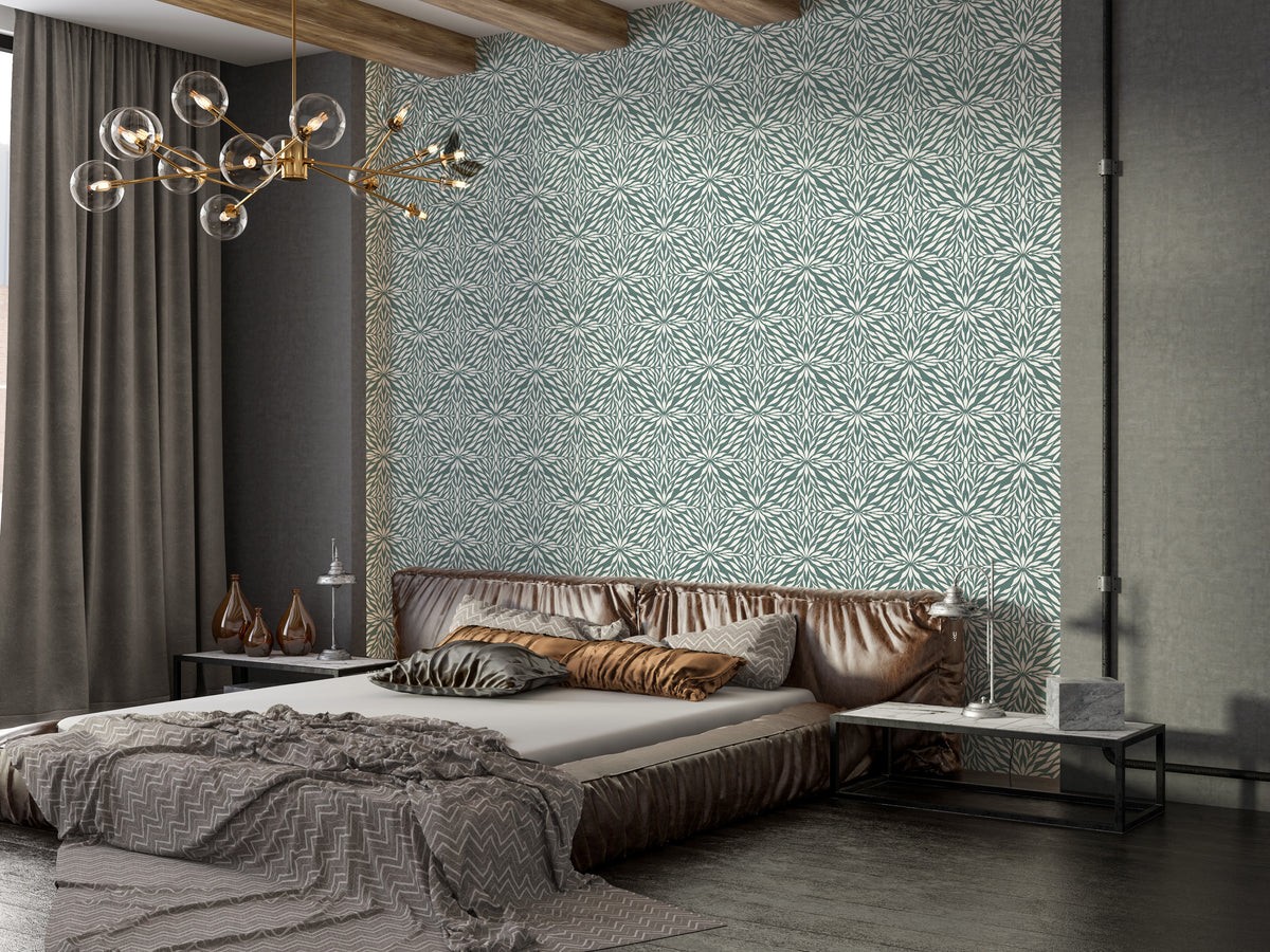 Zenith Leaves wallpaper in sage green behind a brown leather bed with a gold chandelier in a bedroom